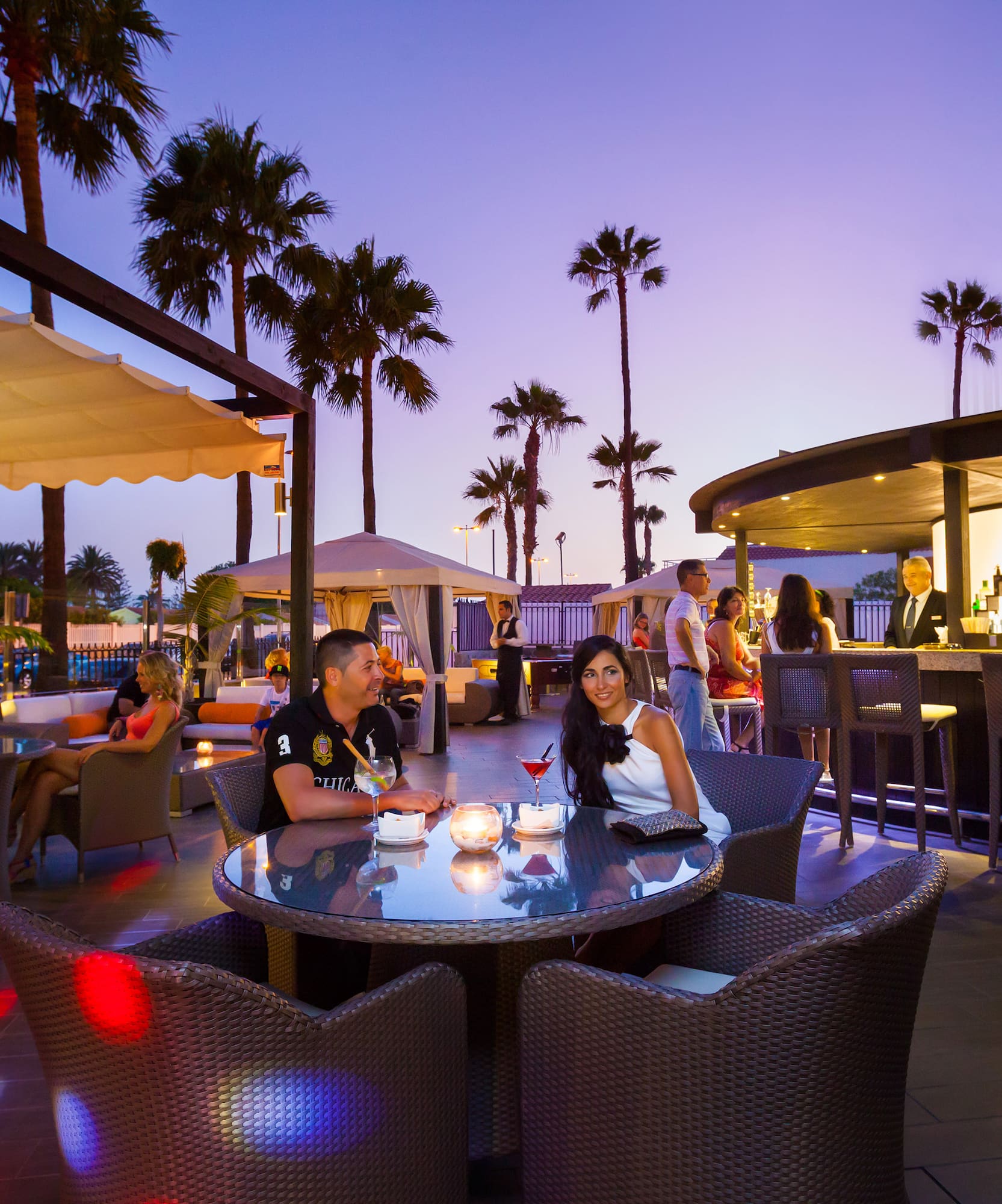 a group of people sitting at a table with tables and chairs