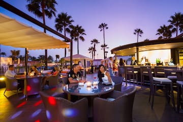 a group of people sitting at a table with tables and chairs