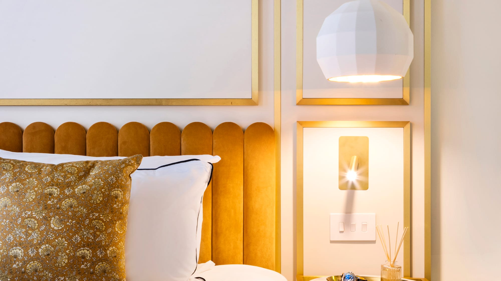 a bed with a tray of liquid and a glass of liquid on it