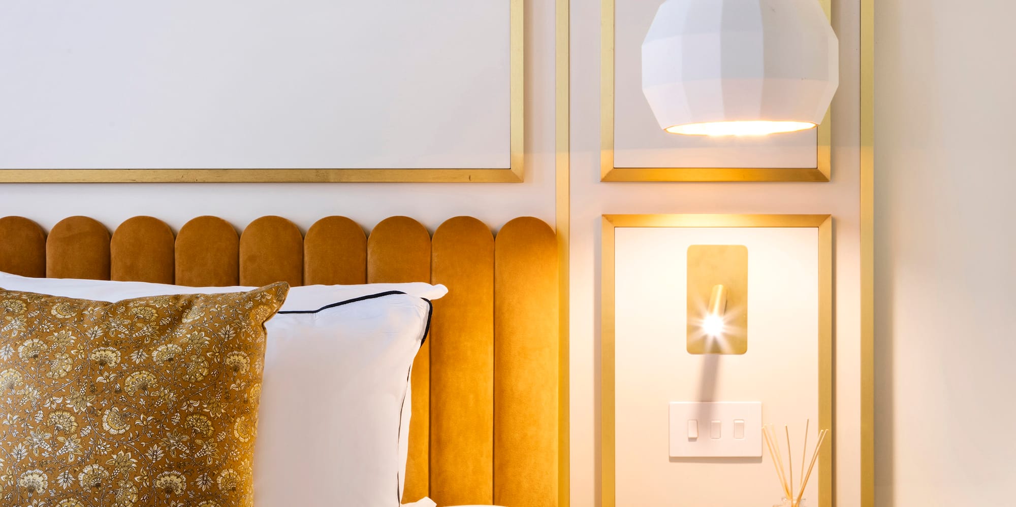 a bed with a tray of liquid and a glass of liquid on it