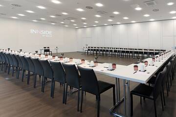 a room with white tables and chairs