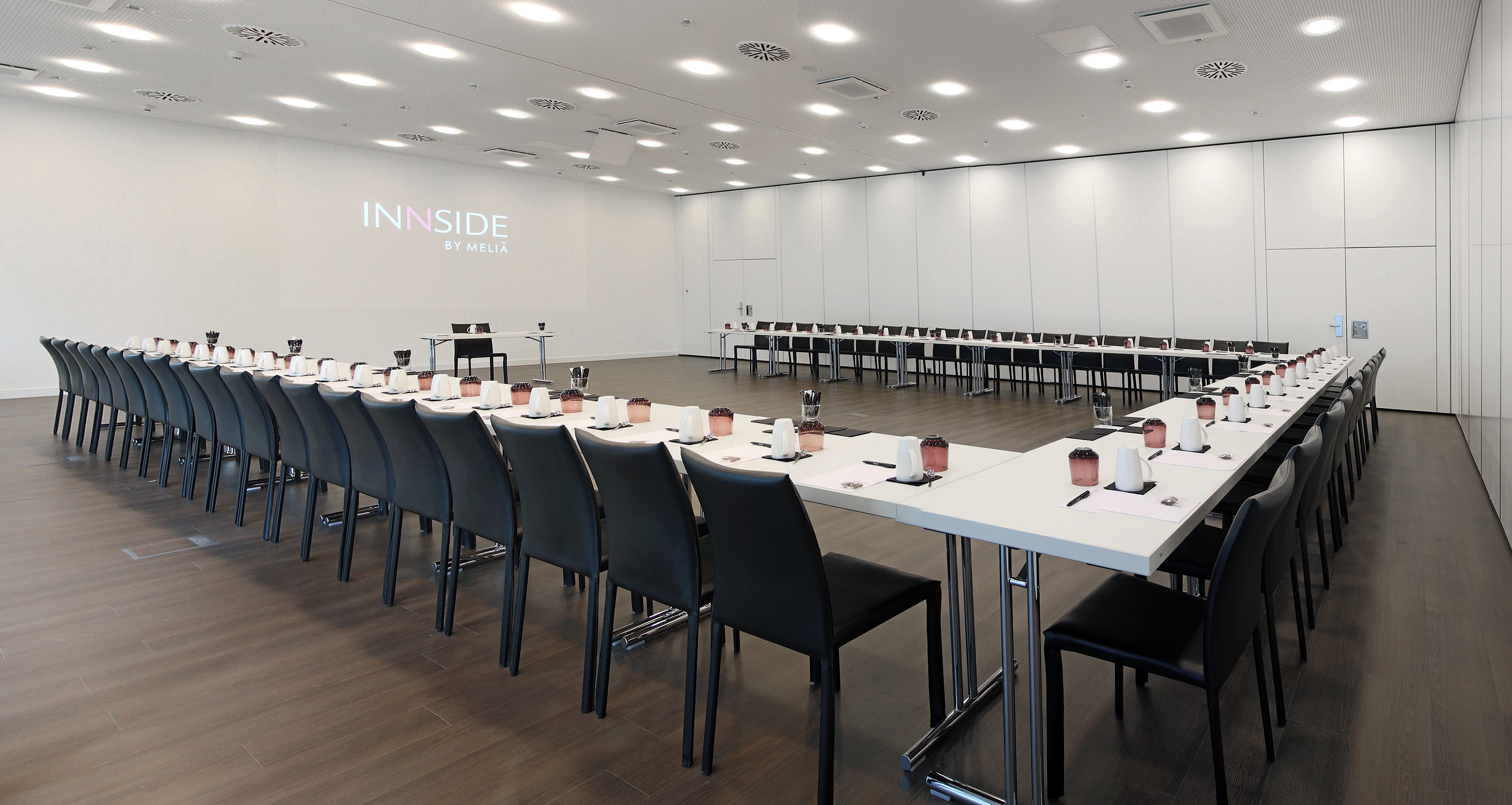 a room with white tables and chairs