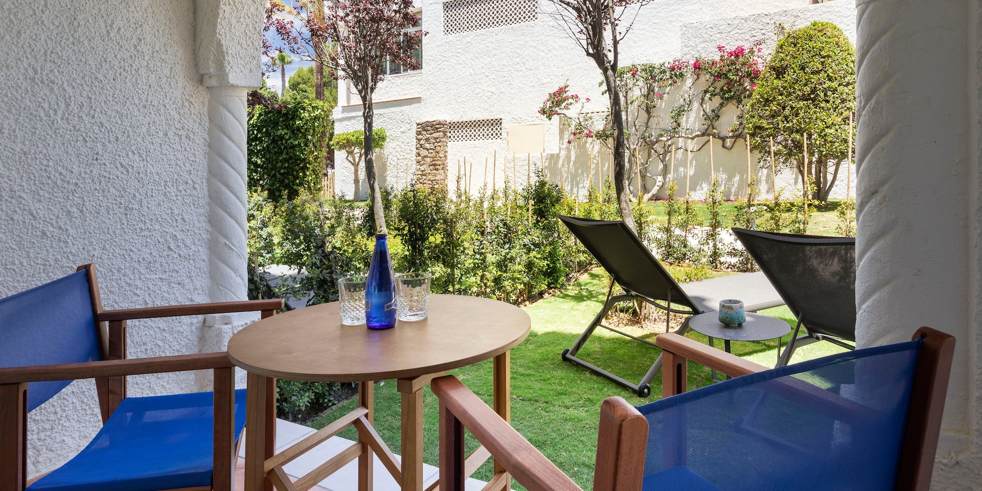 a table and chairs outside with a building in the background