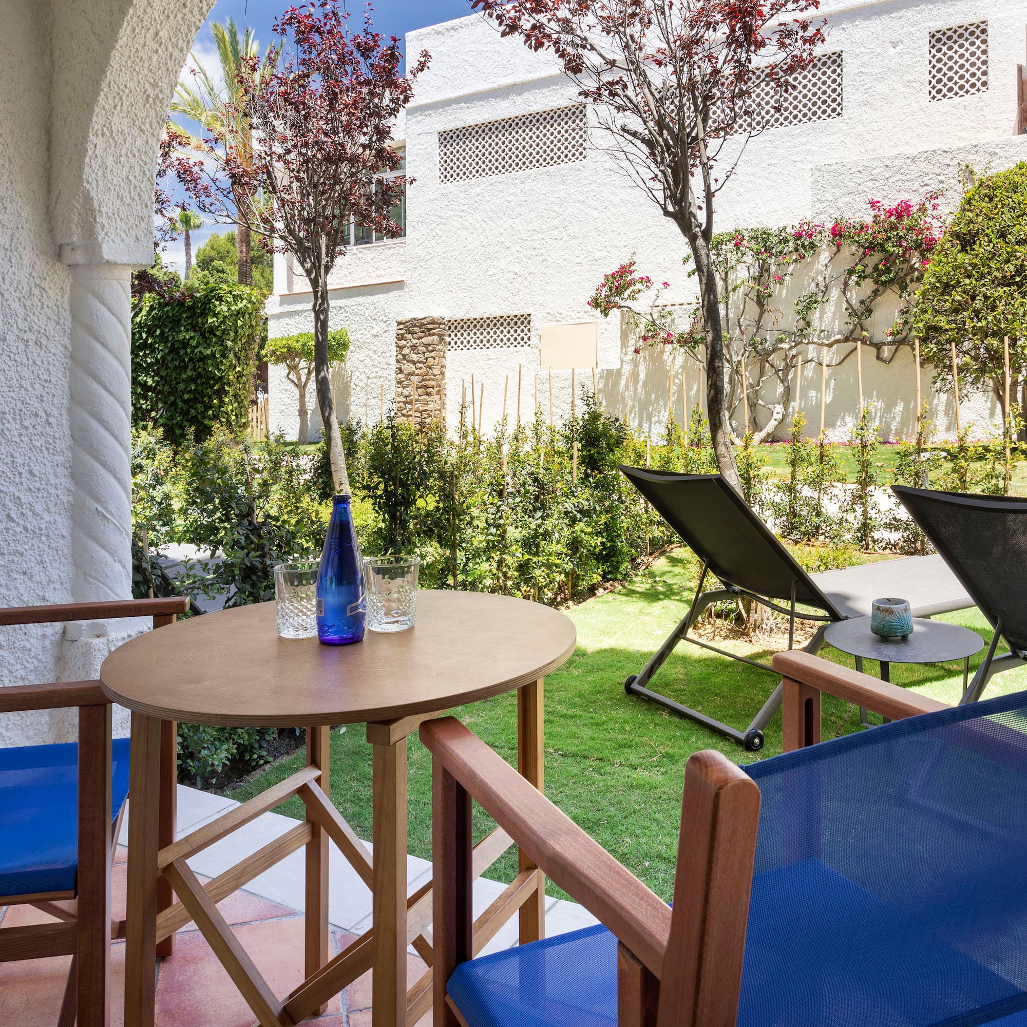 a table and chairs outside with a building in the background
