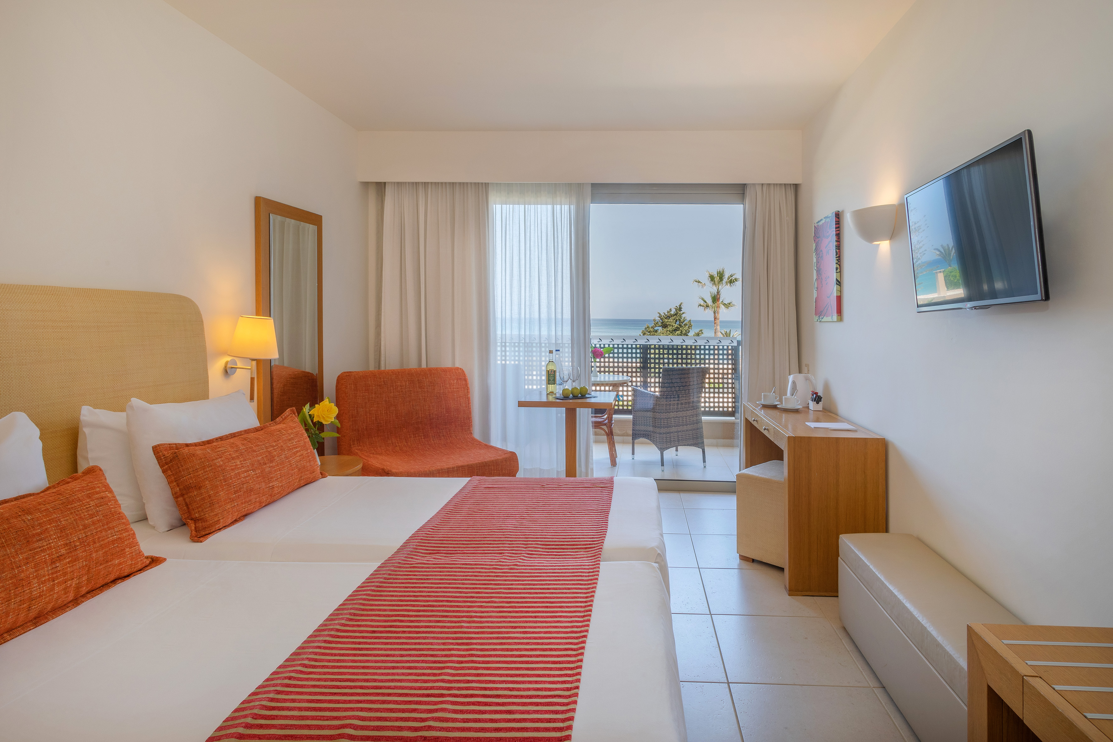 a room with two beds and a table and chairs