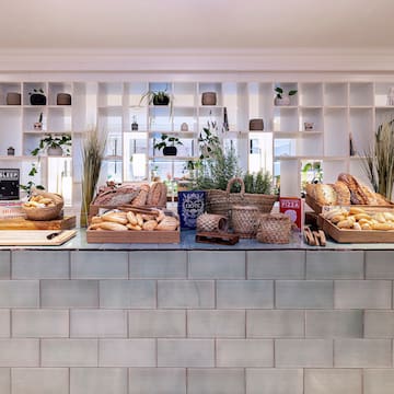 a counter with baskets of bread and plants