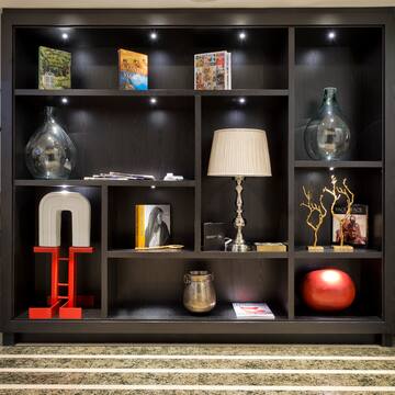 a black bookcase with various objects on it
