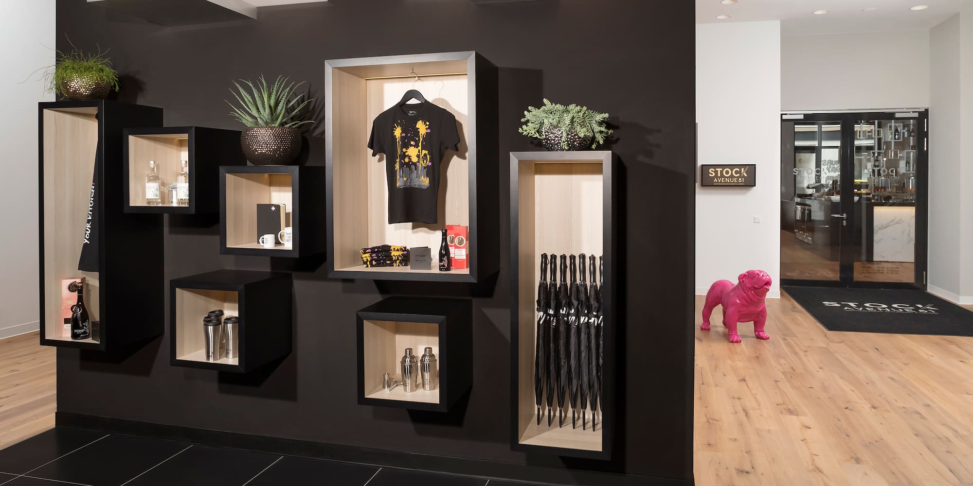 a black wall with shelves and a pink dog