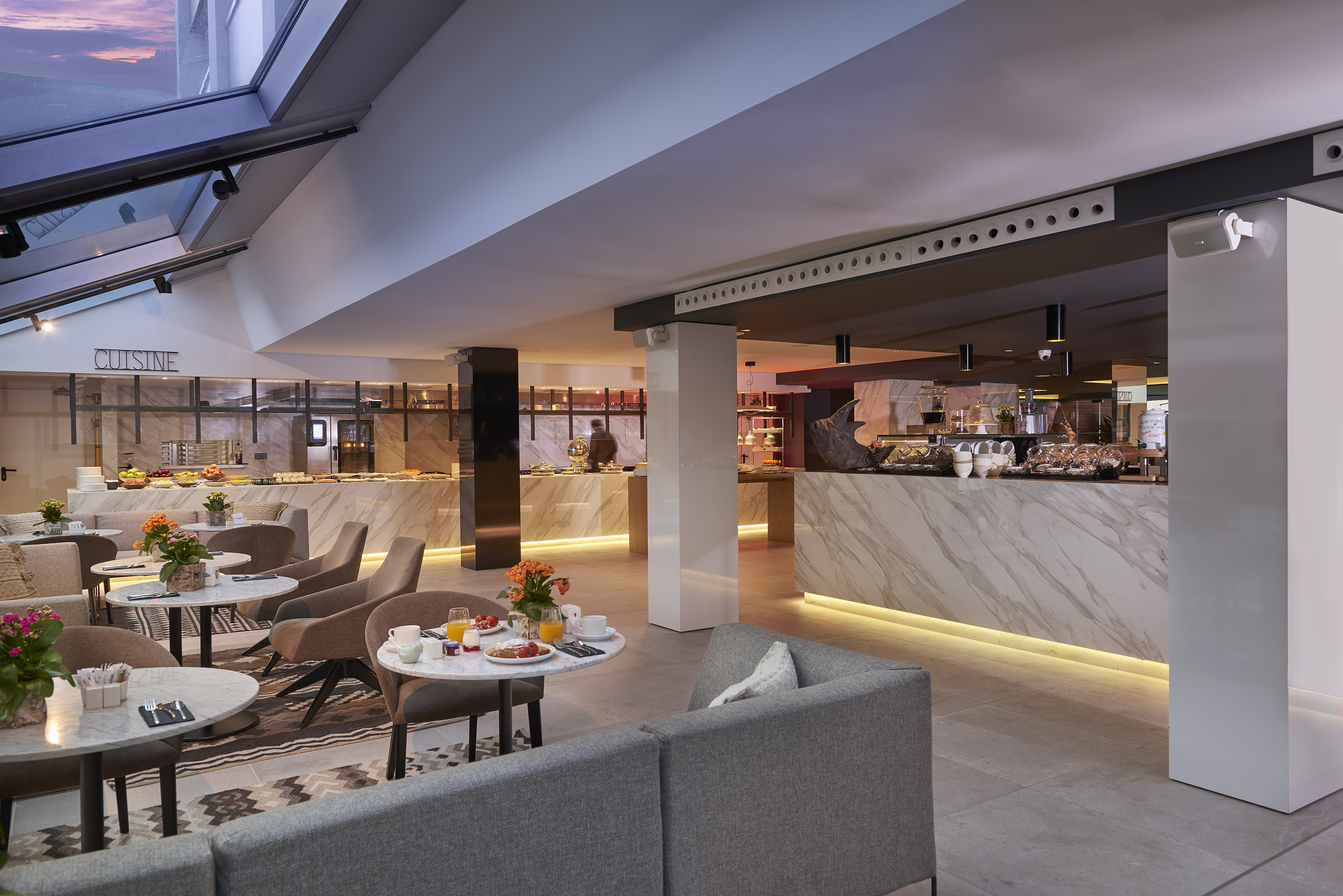 a room with a counter and tables and chairs