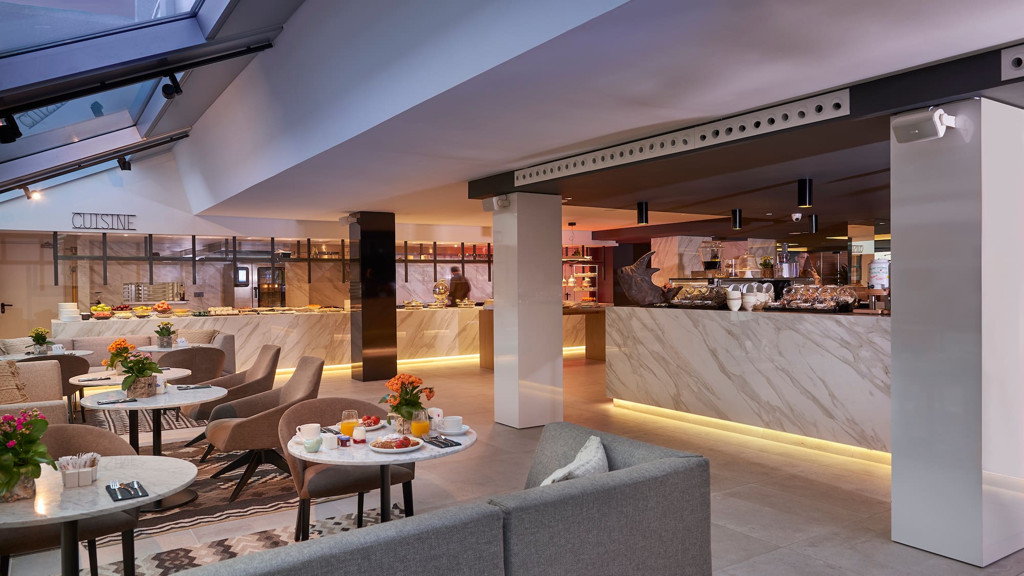 a room with a counter and tables and chairs