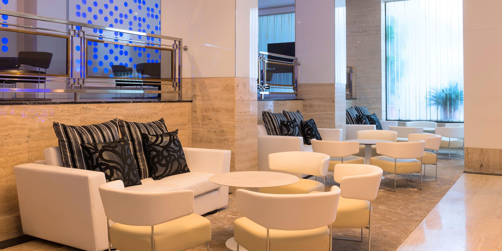 a room with white chairs and tables