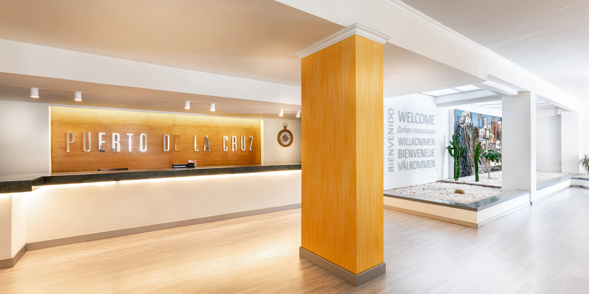 a lobby with a sign and a stone wall