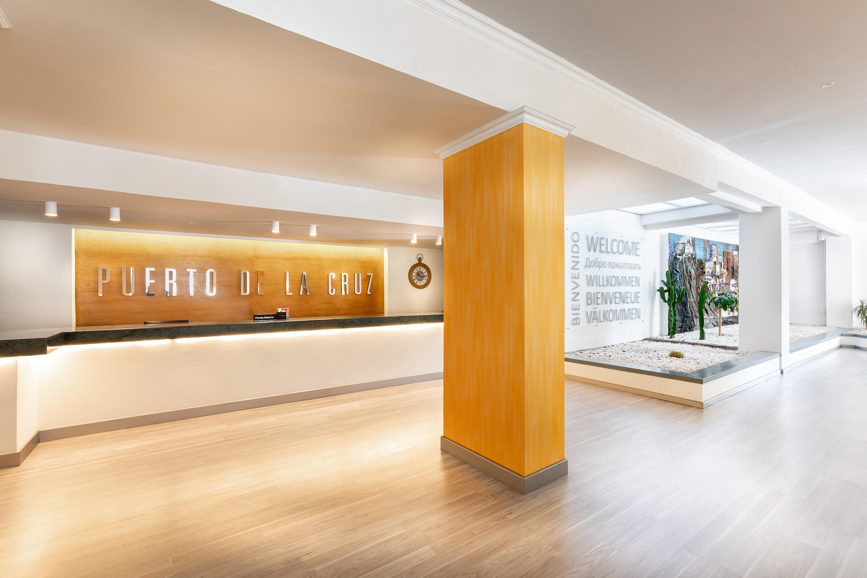 a lobby with a sign and a stone wall