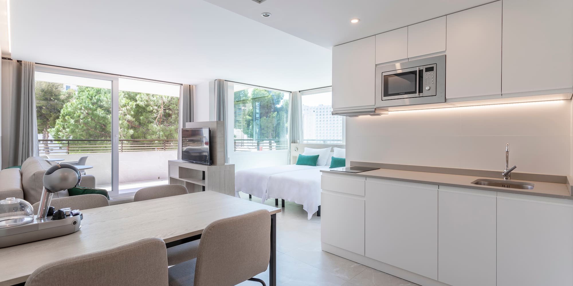 a room with a kitchen and dining area
