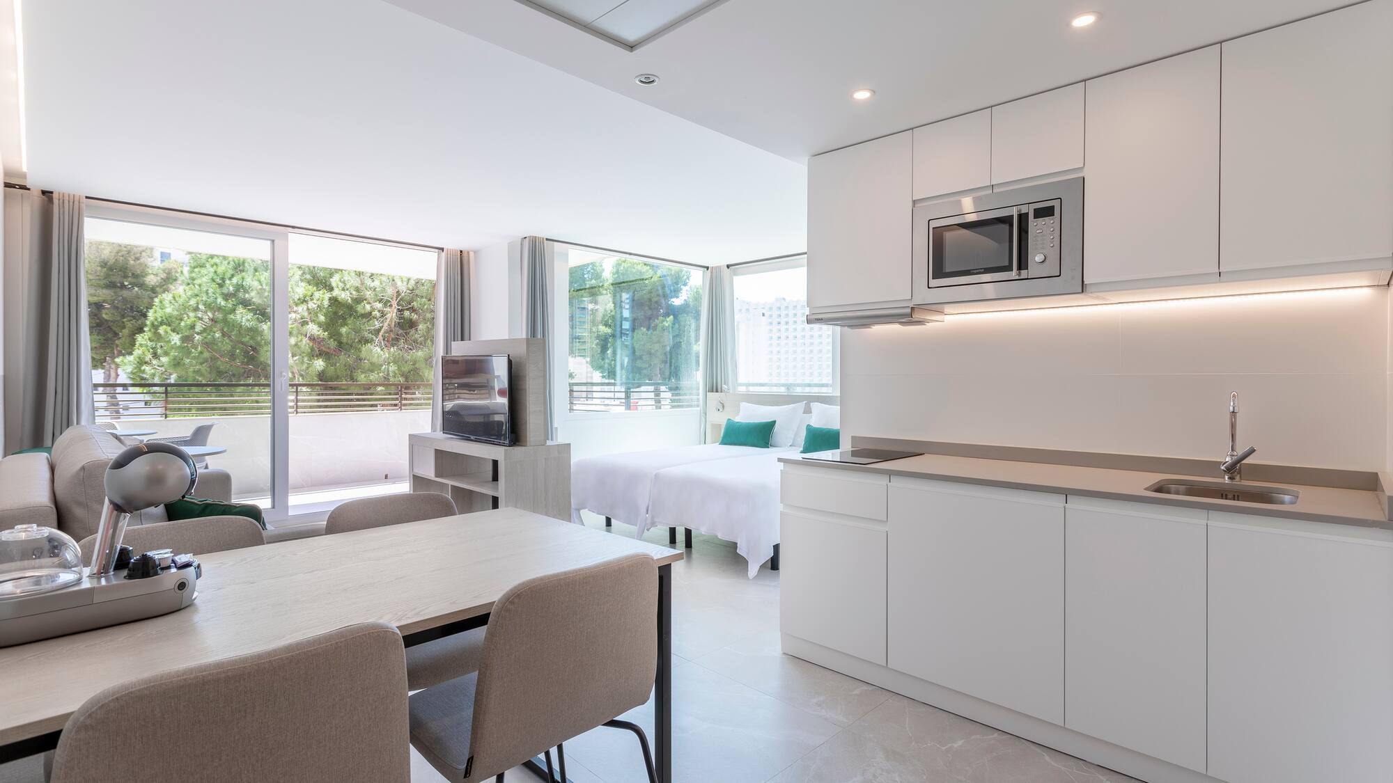 a room with a kitchen and dining area