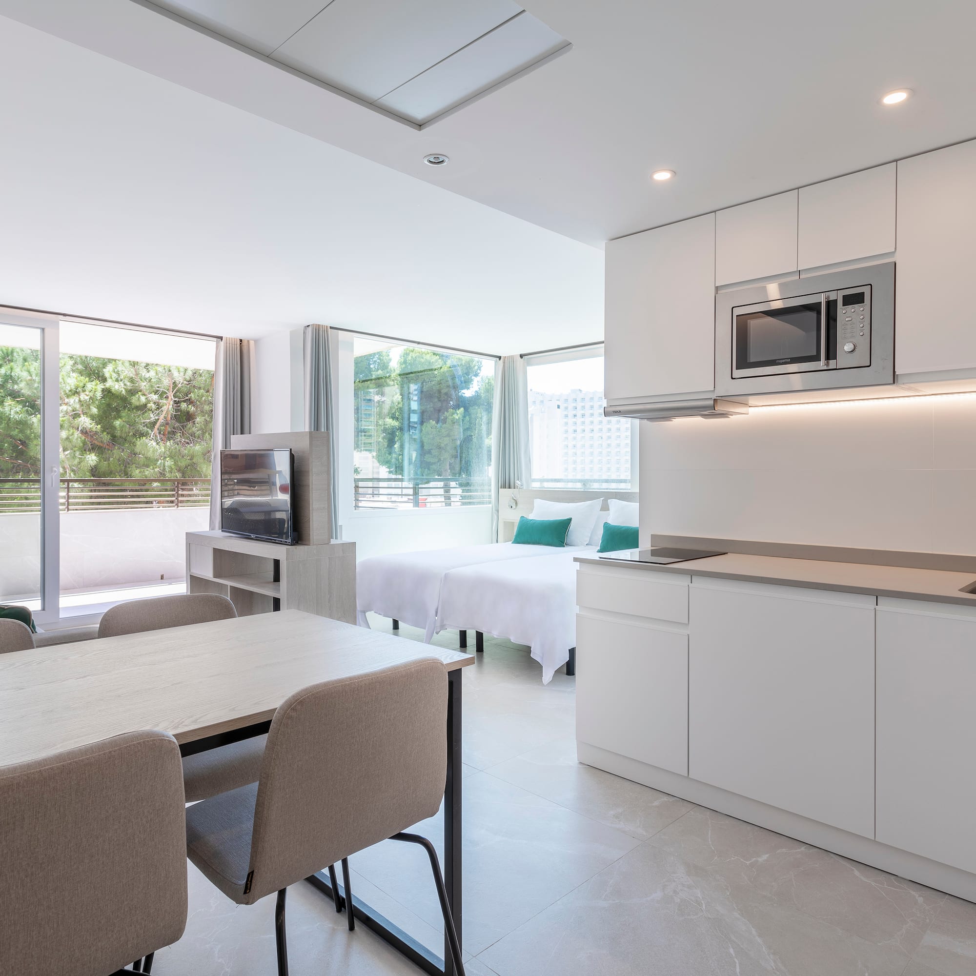 a room with a kitchen and dining area