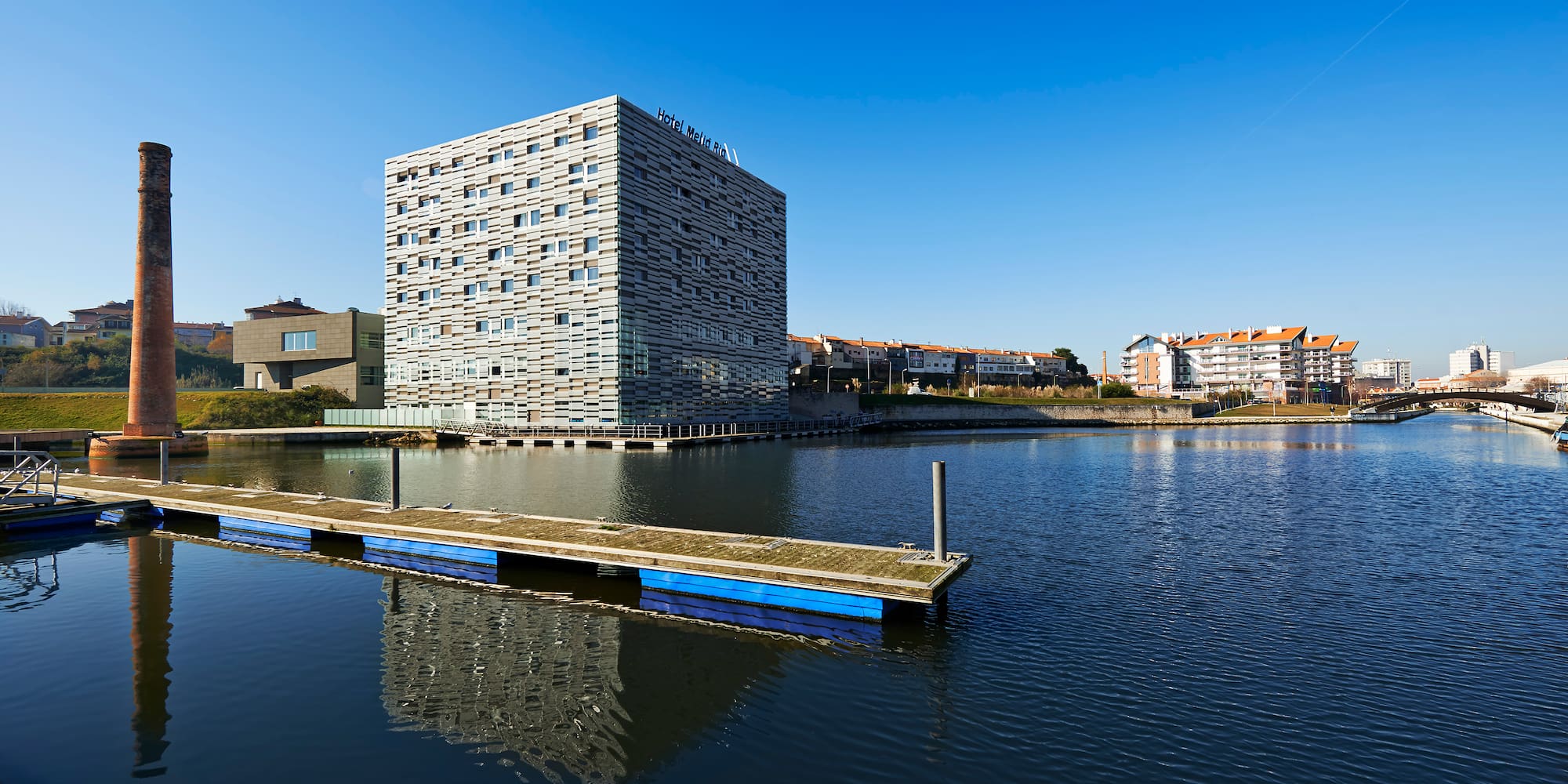 a building next to a body of water