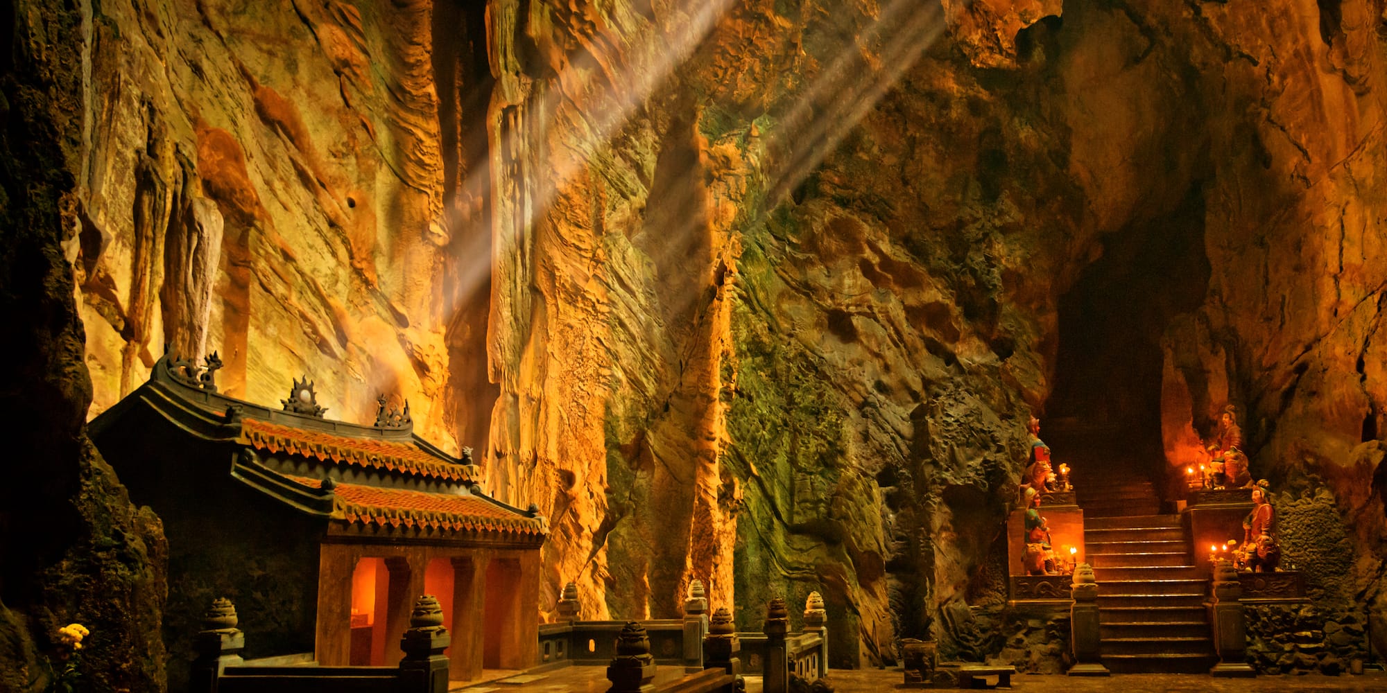 a cave with a temple and stairs
