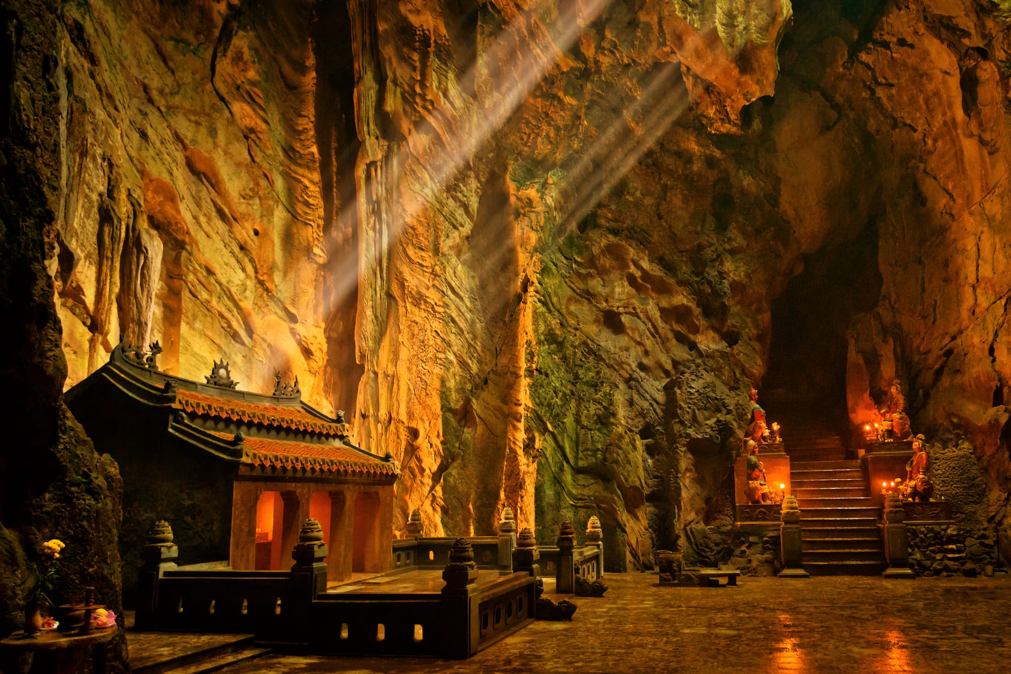 a cave with a temple and stairs