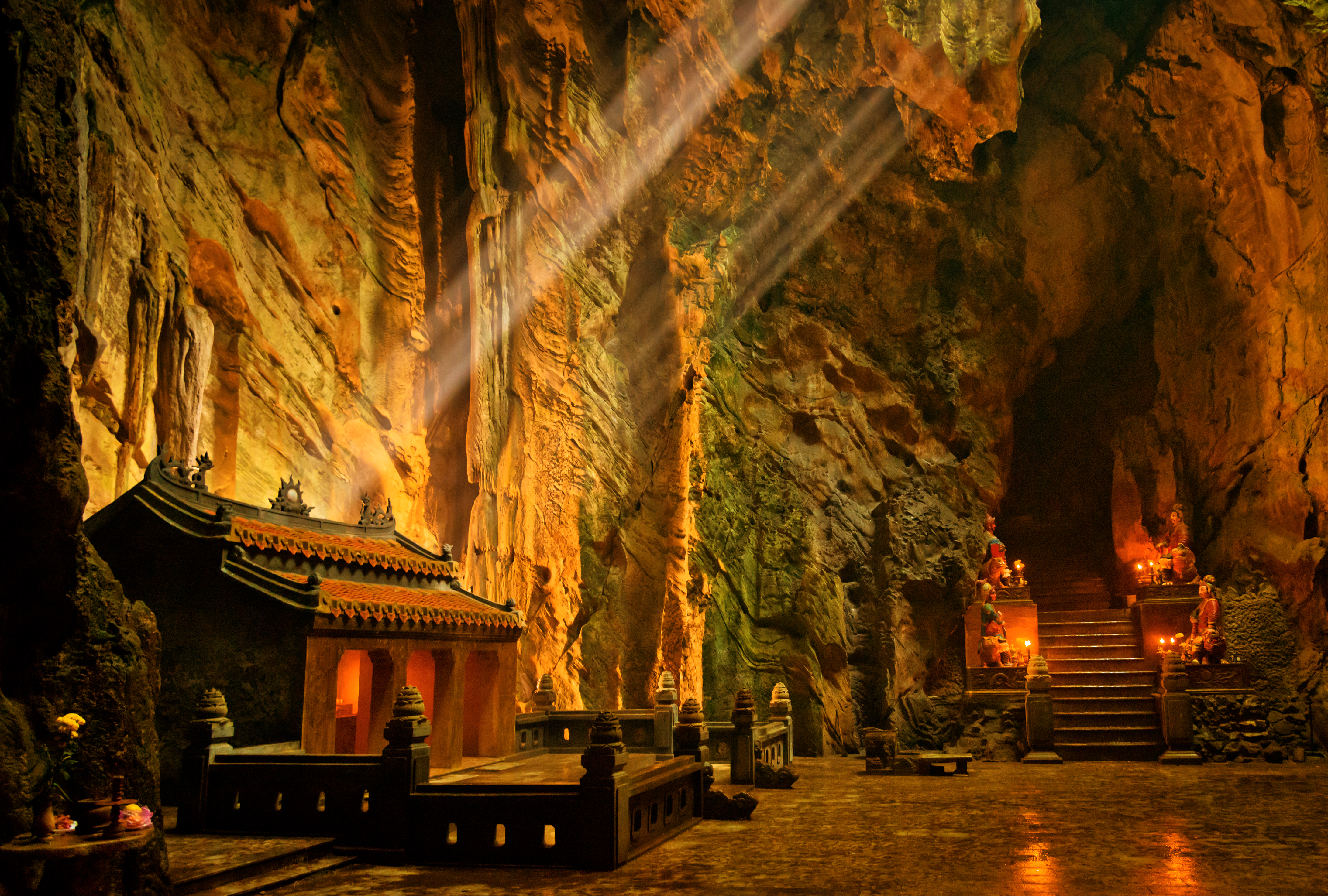 a cave with a temple and stairs