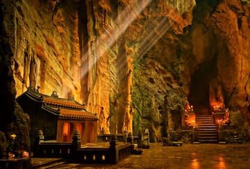 a cave with a temple and stairs