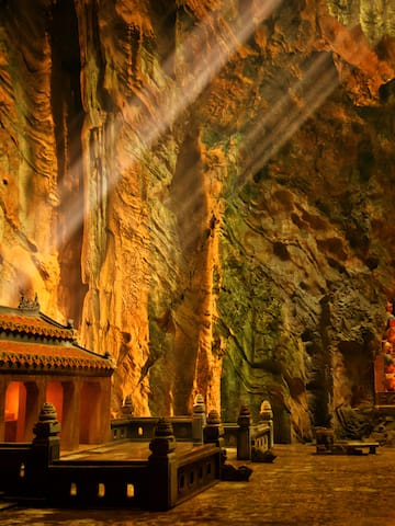 a cave with a temple and stairs