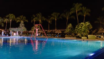 a person on a swing in a pool at night