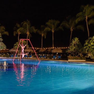 a person on a swing in a pool at night