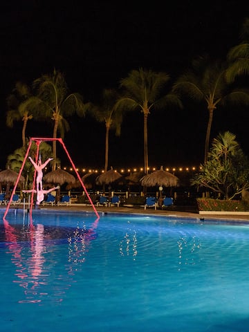 a person on a swing in a pool at night