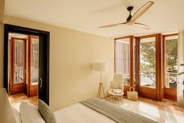 a bedroom with a fan and a bed