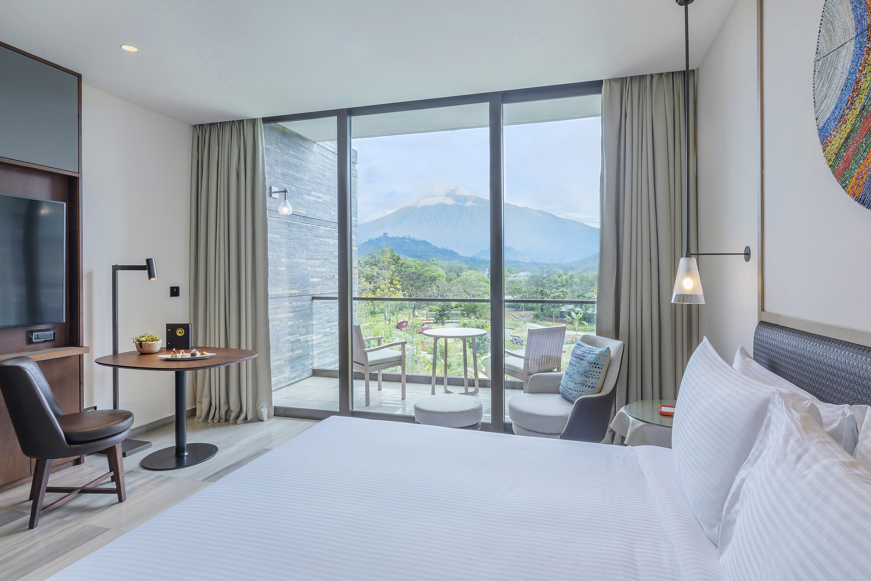 a room with a bed and a table and chairs