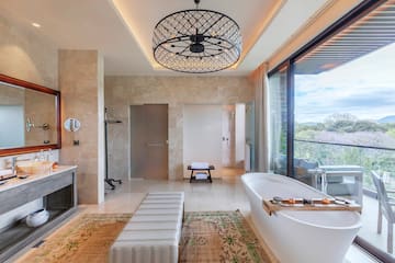 a bathroom with a tub and a fireplace