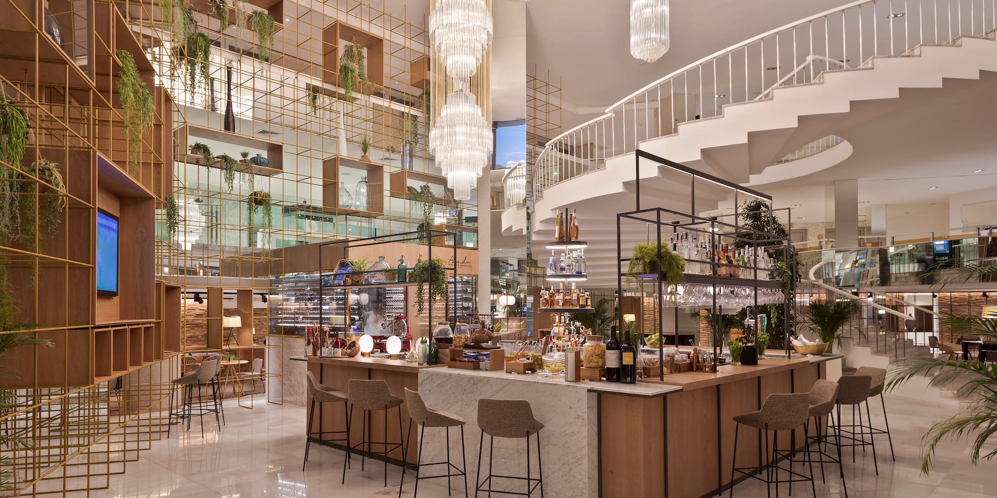 a large room with a staircase and a bar