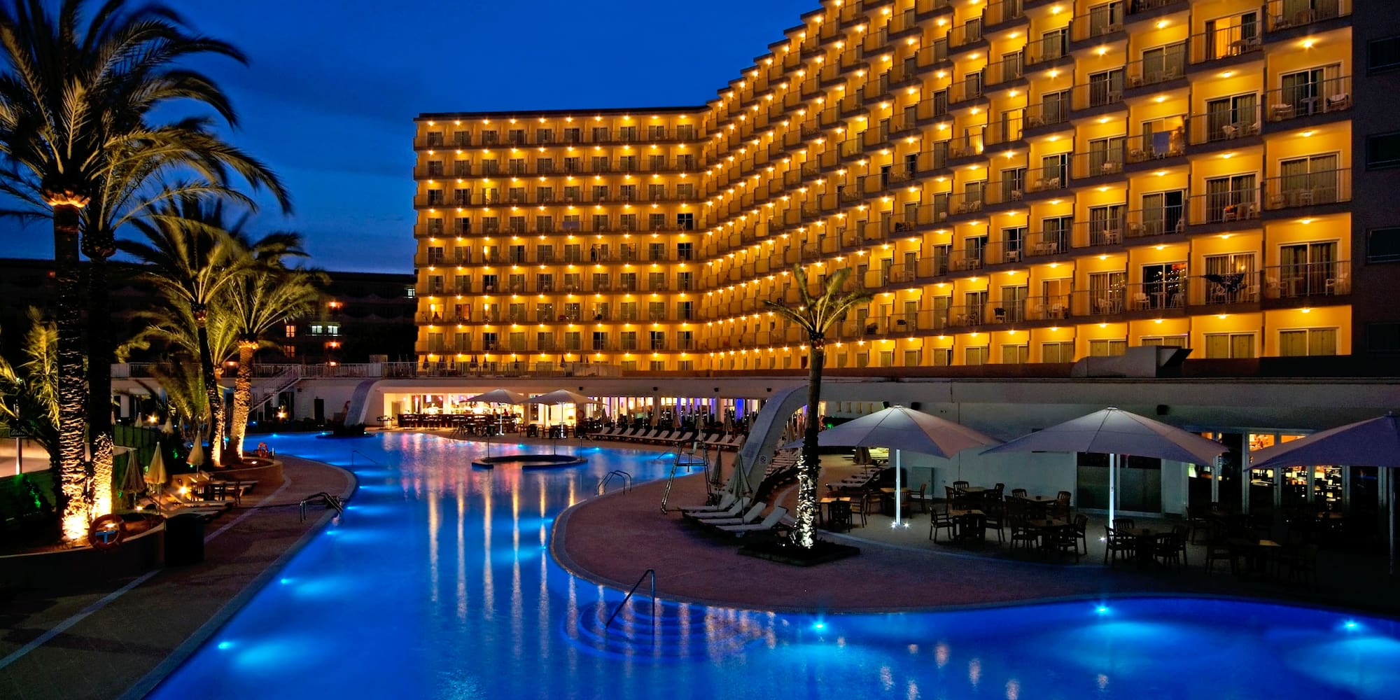 a hotel with a pool and palm trees