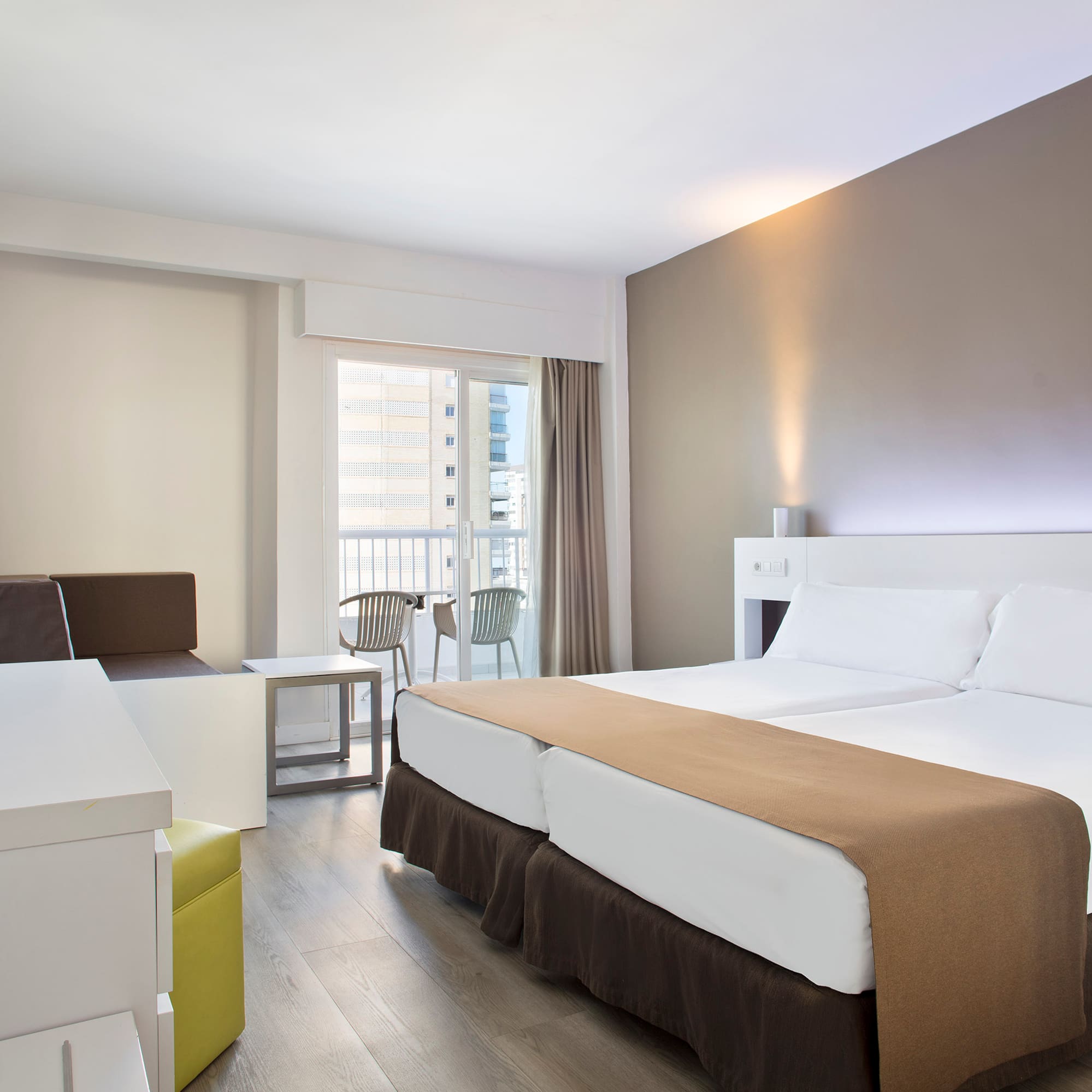 a room with two beds and a table