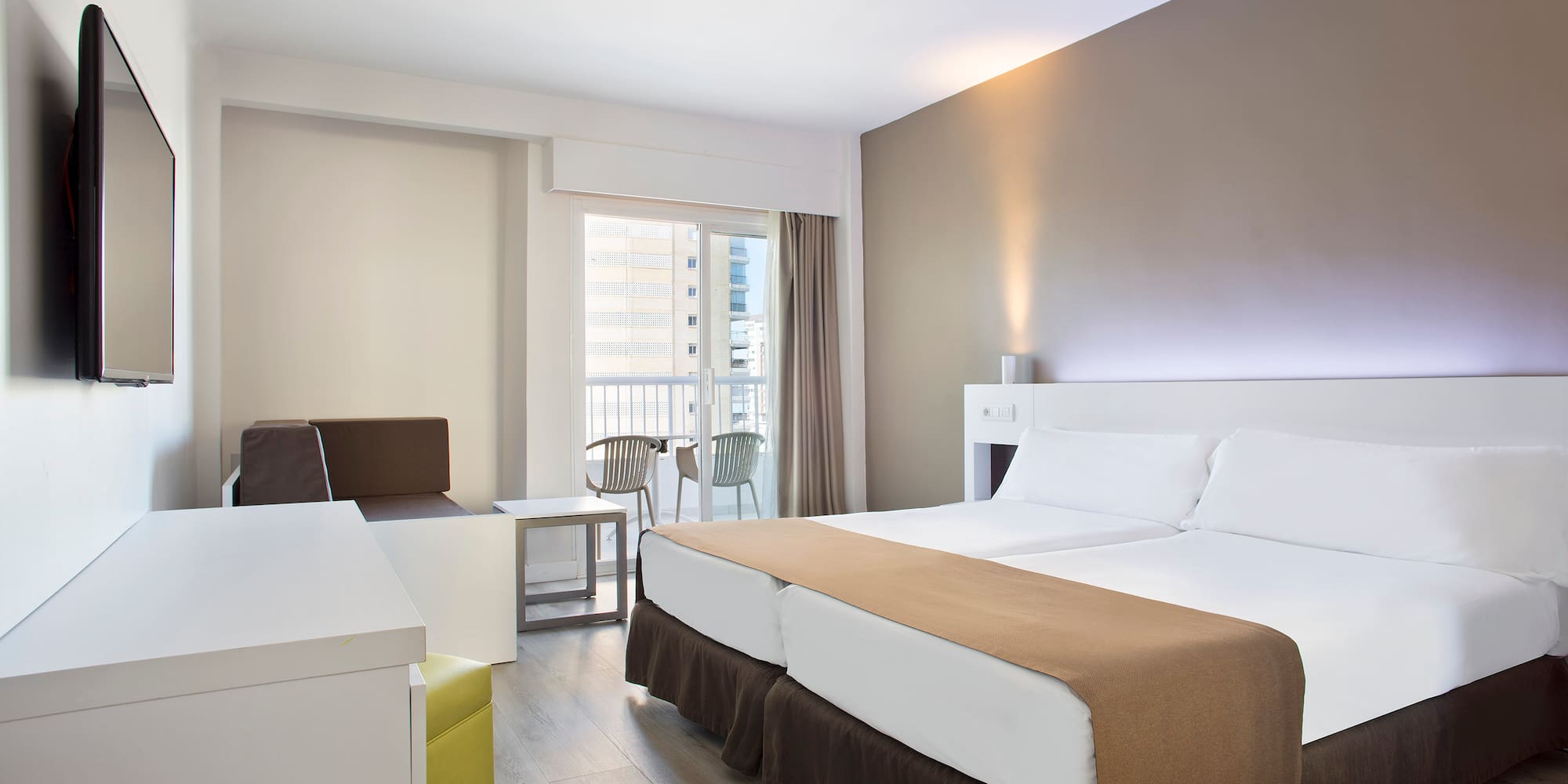 a room with two beds and a table