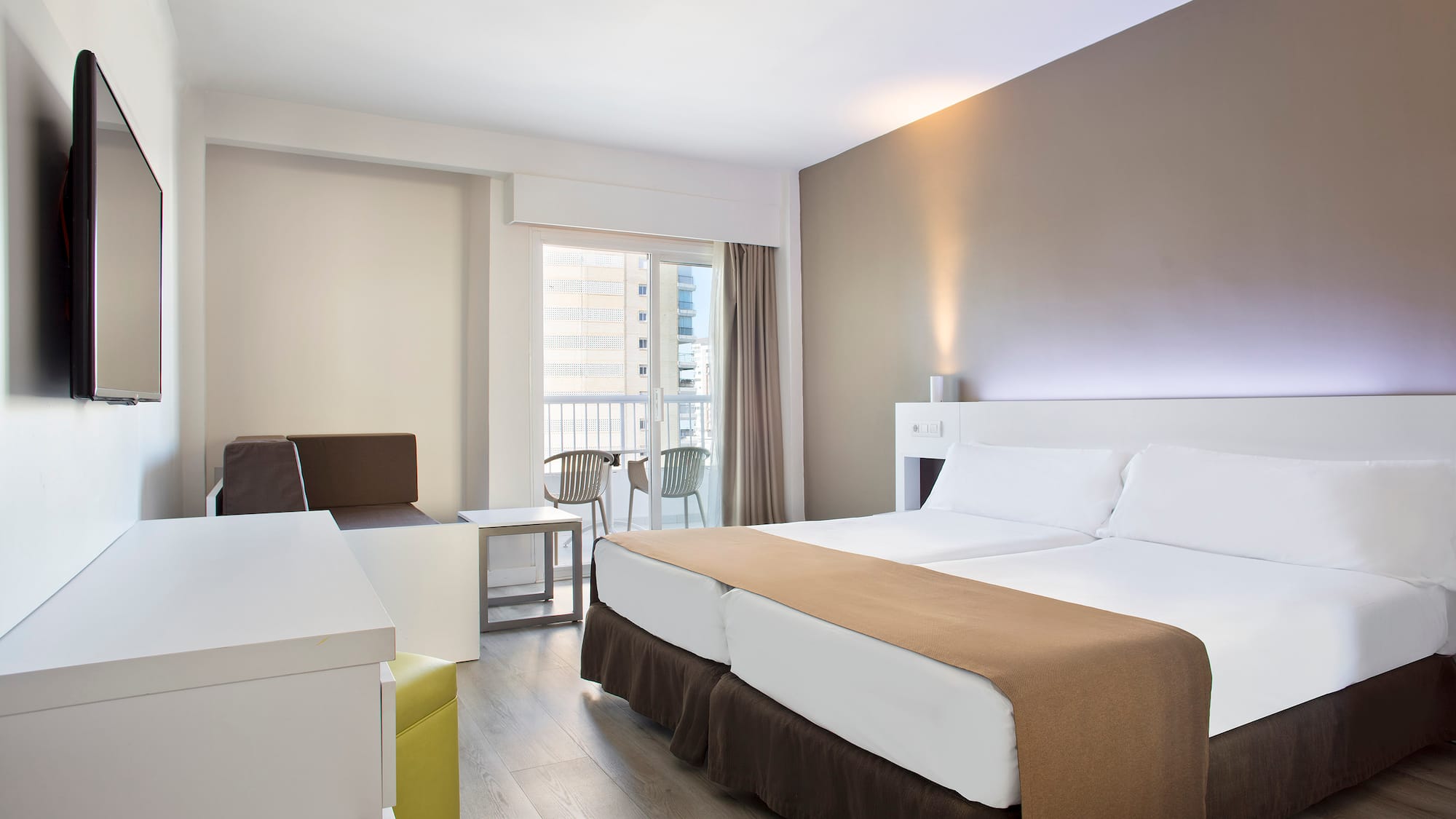 a room with two beds and a table