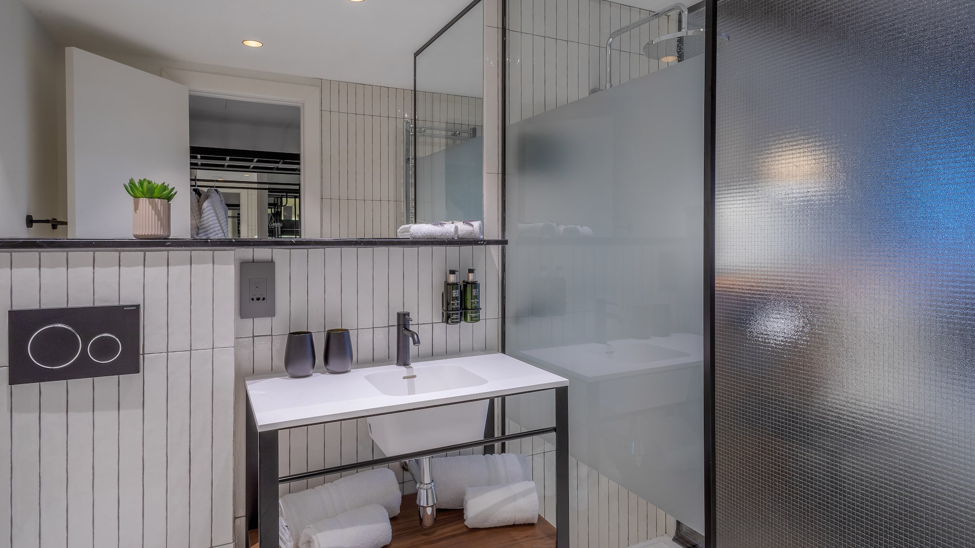 a bathroom with a glass shower and sink