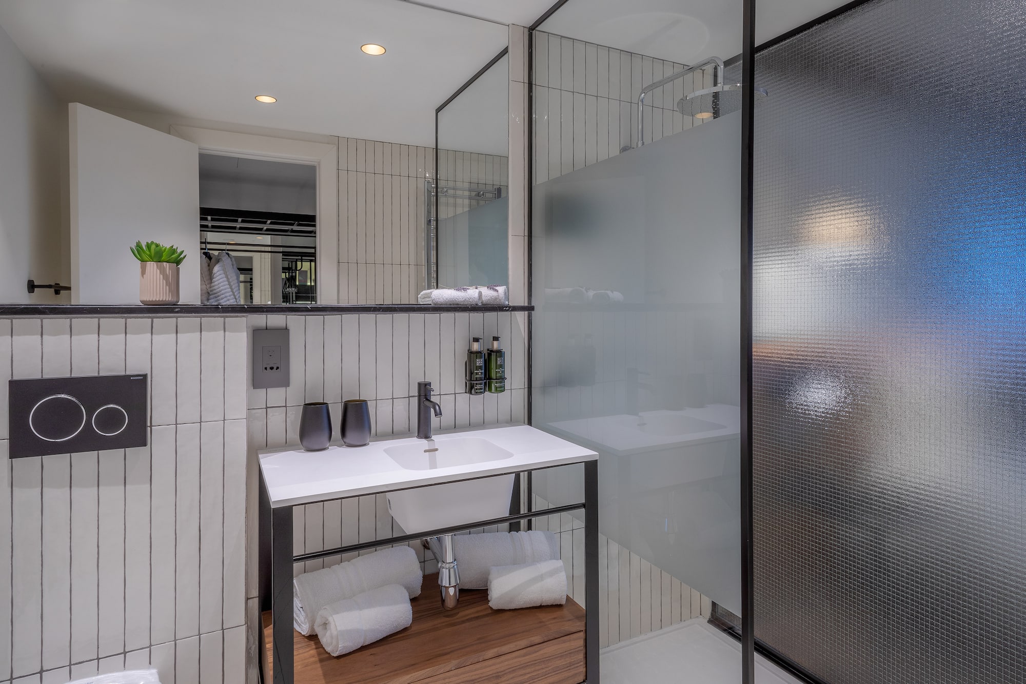 a bathroom with a glass shower and sink