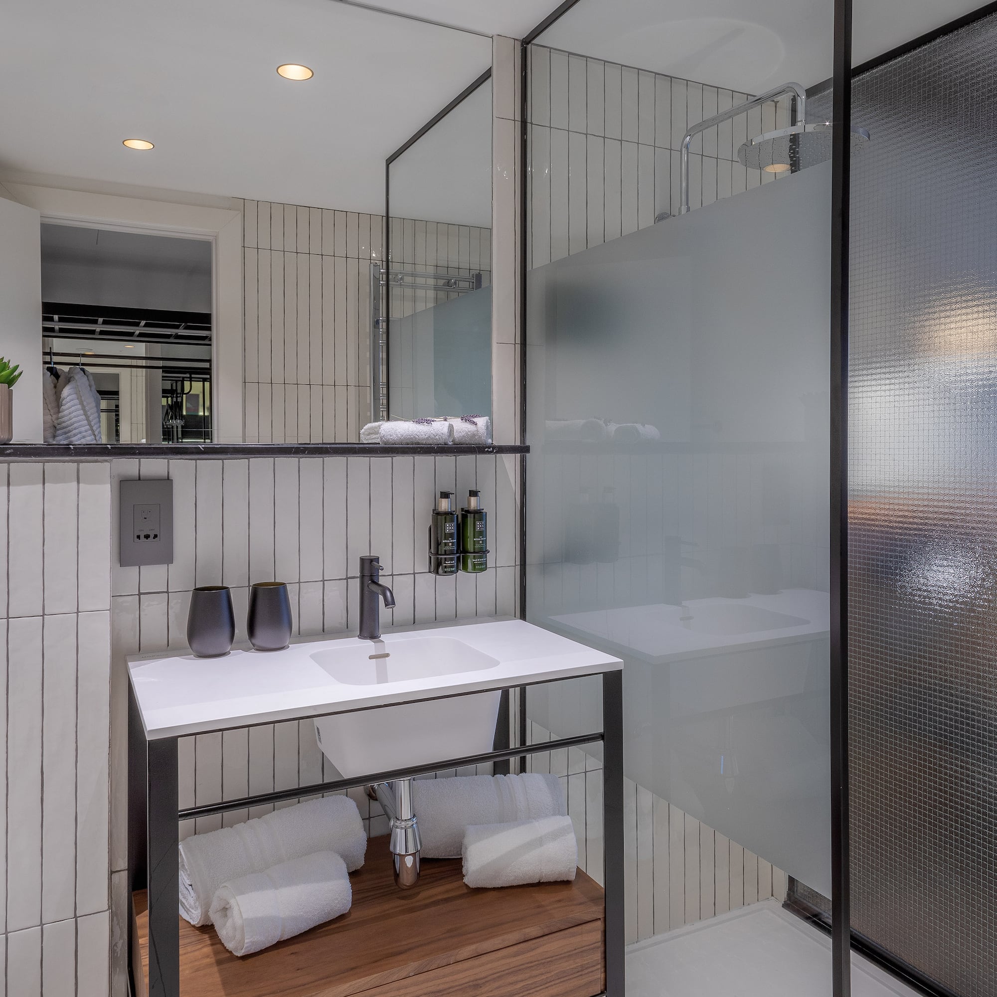 a bathroom with a glass shower and sink