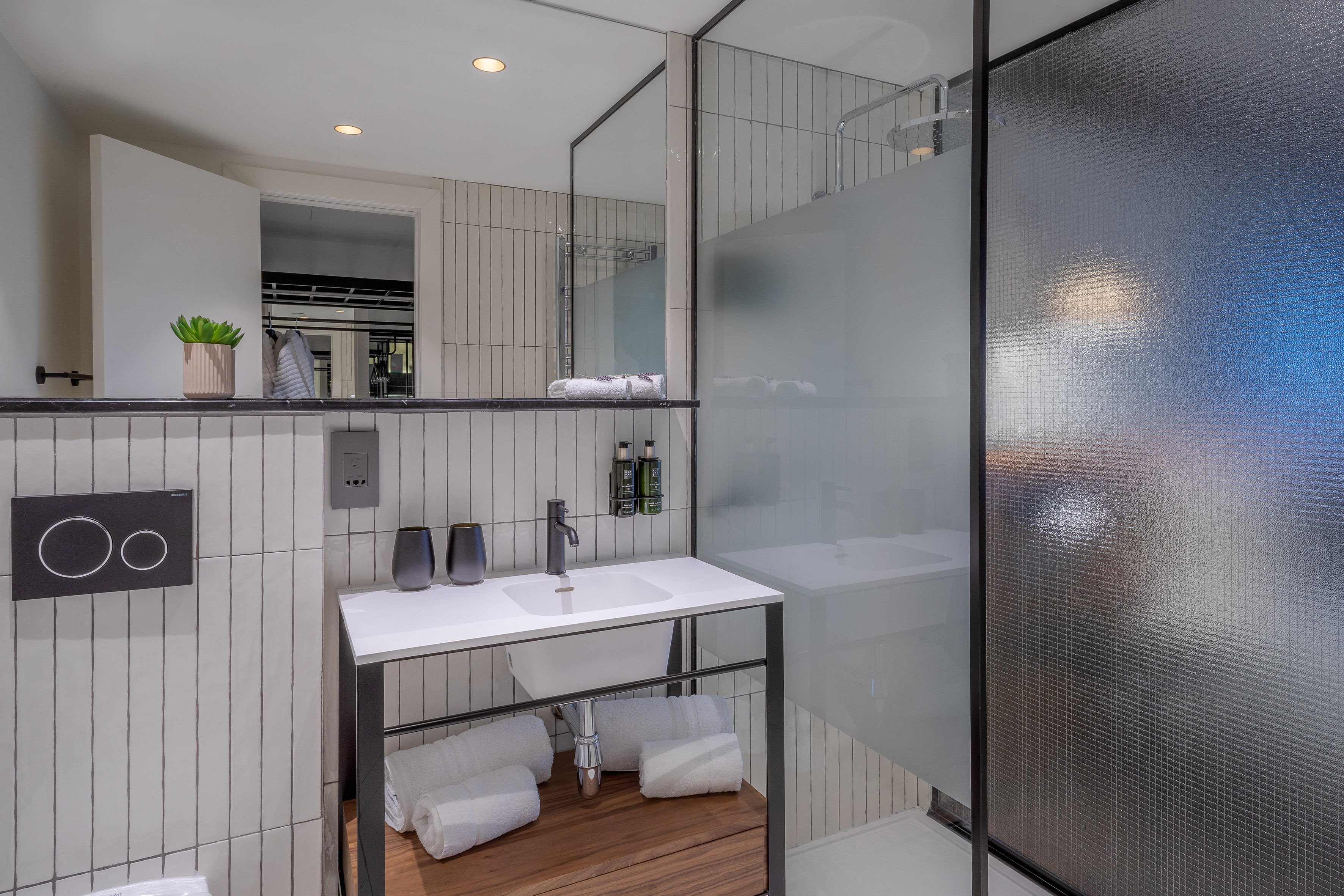 a bathroom with a glass shower and sink