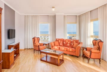 a living room with a couch and chairs