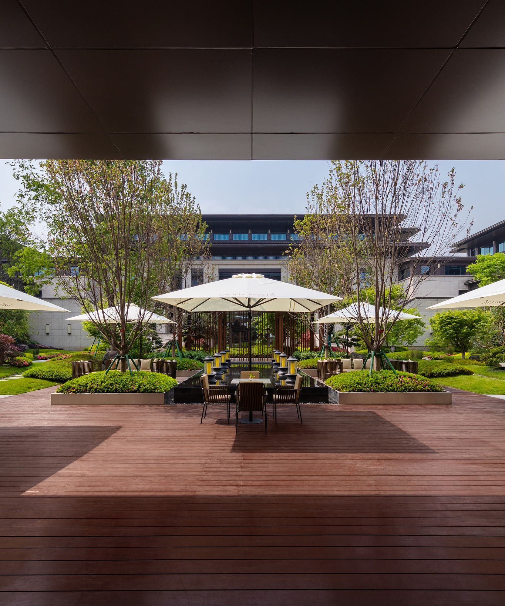a patio with umbrellas and chairs