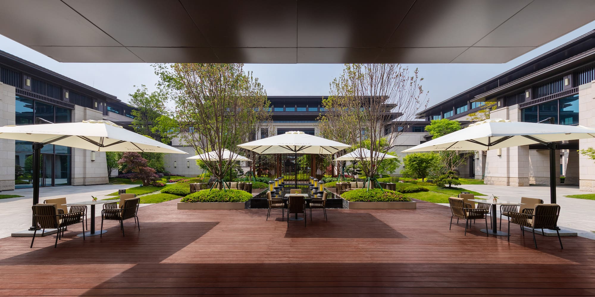 a patio with umbrellas and chairs