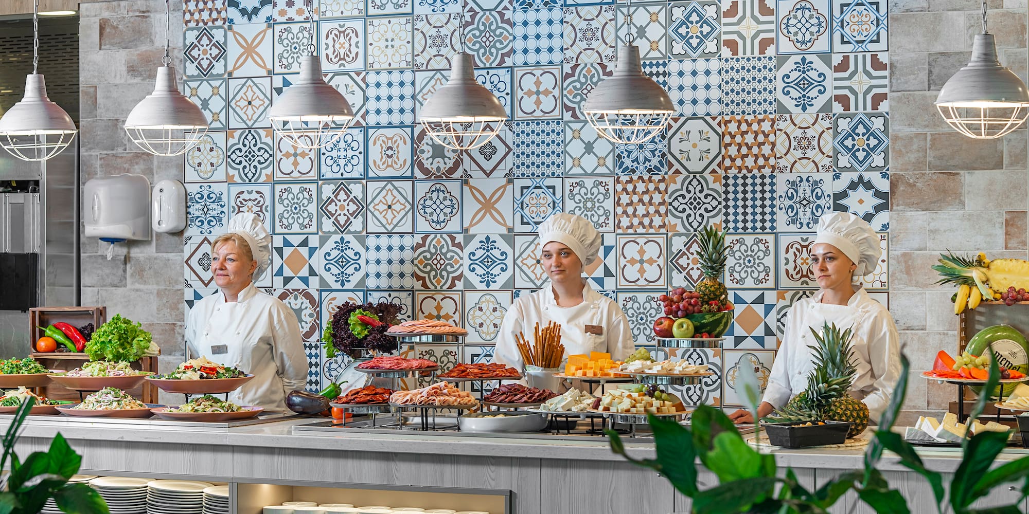 a group of people in chef's uniforms standing behind a counter