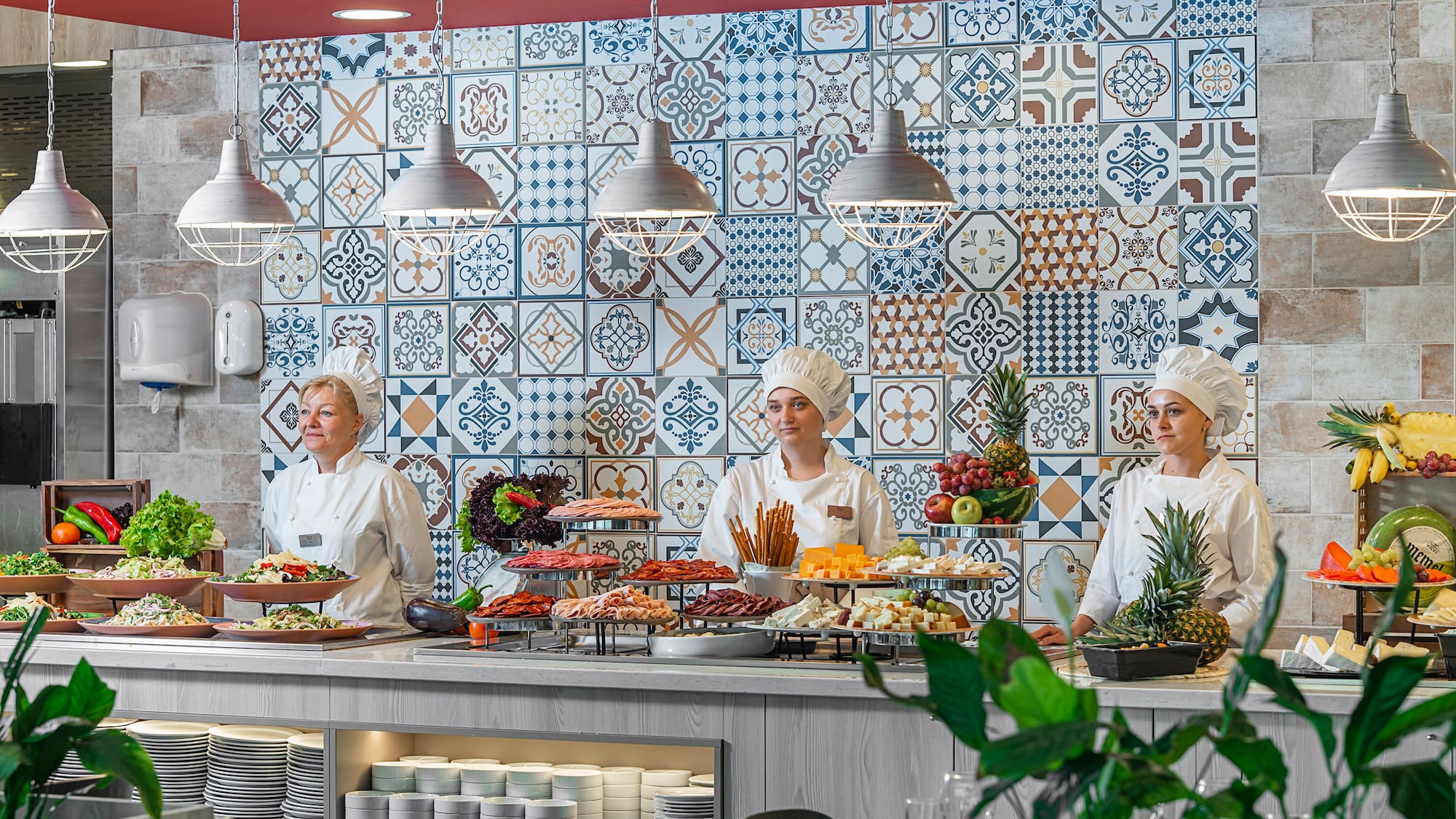a group of people in chef's uniforms standing behind a counter