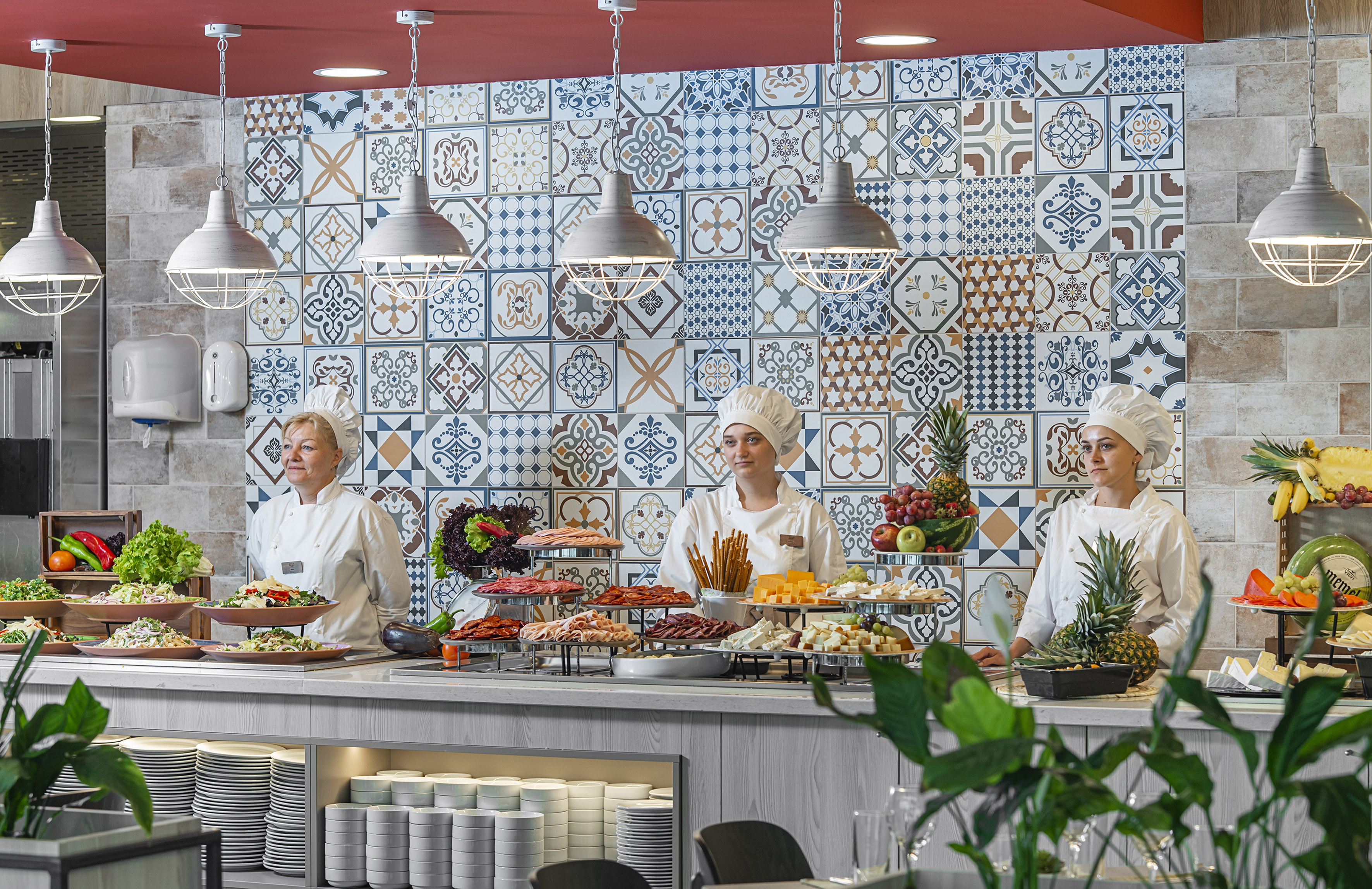 a group of people in chef's uniforms standing behind a counter