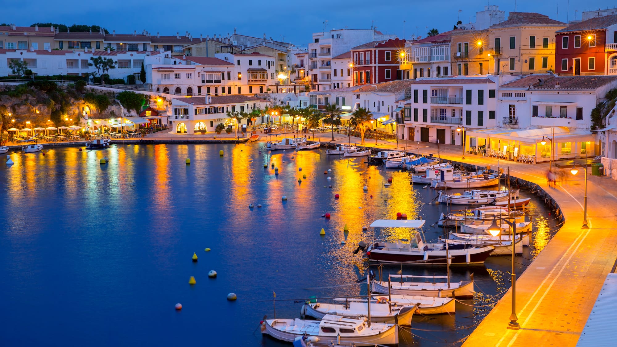 a harbor with boats and buildings in the background