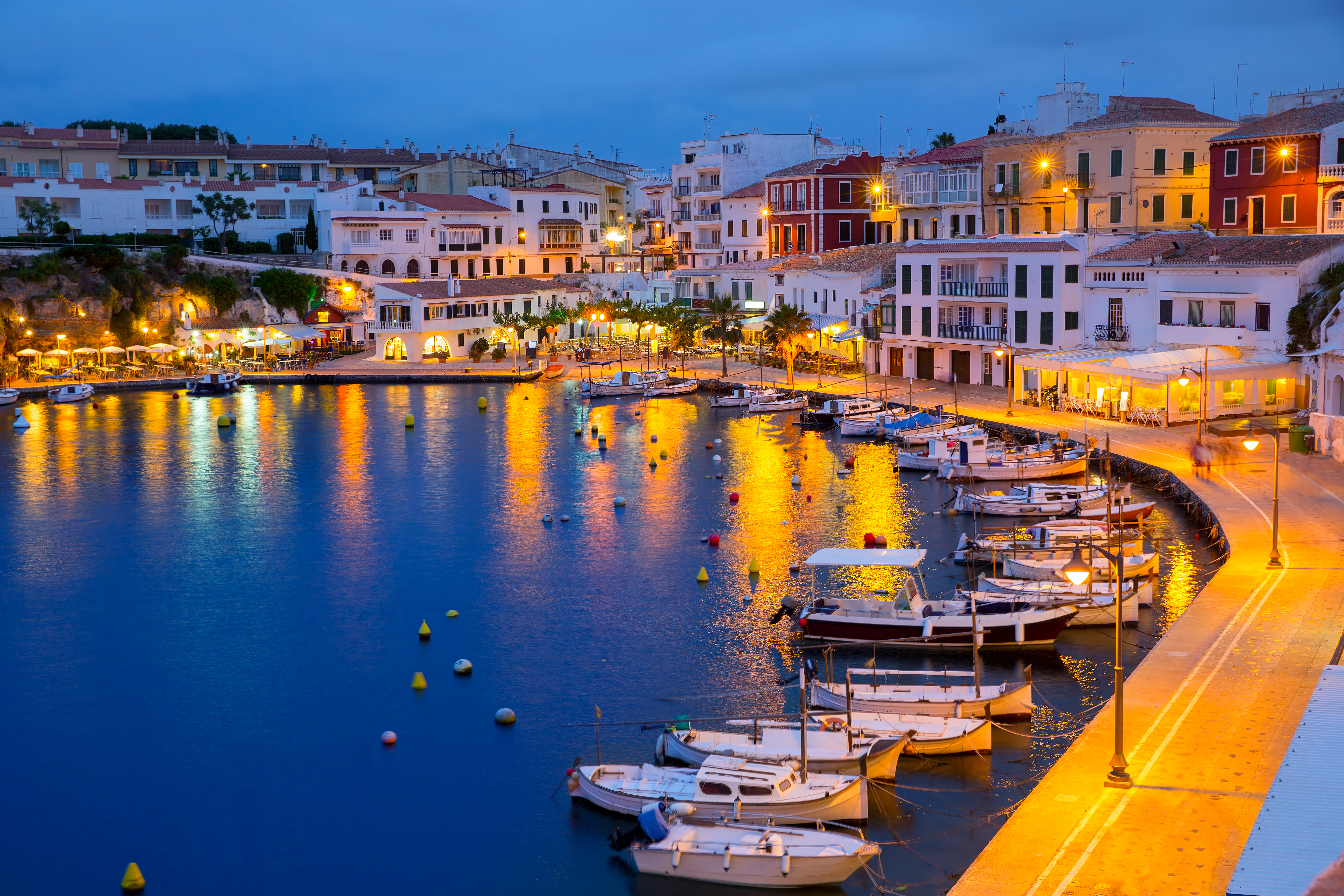 a harbor with boats and buildings in the background