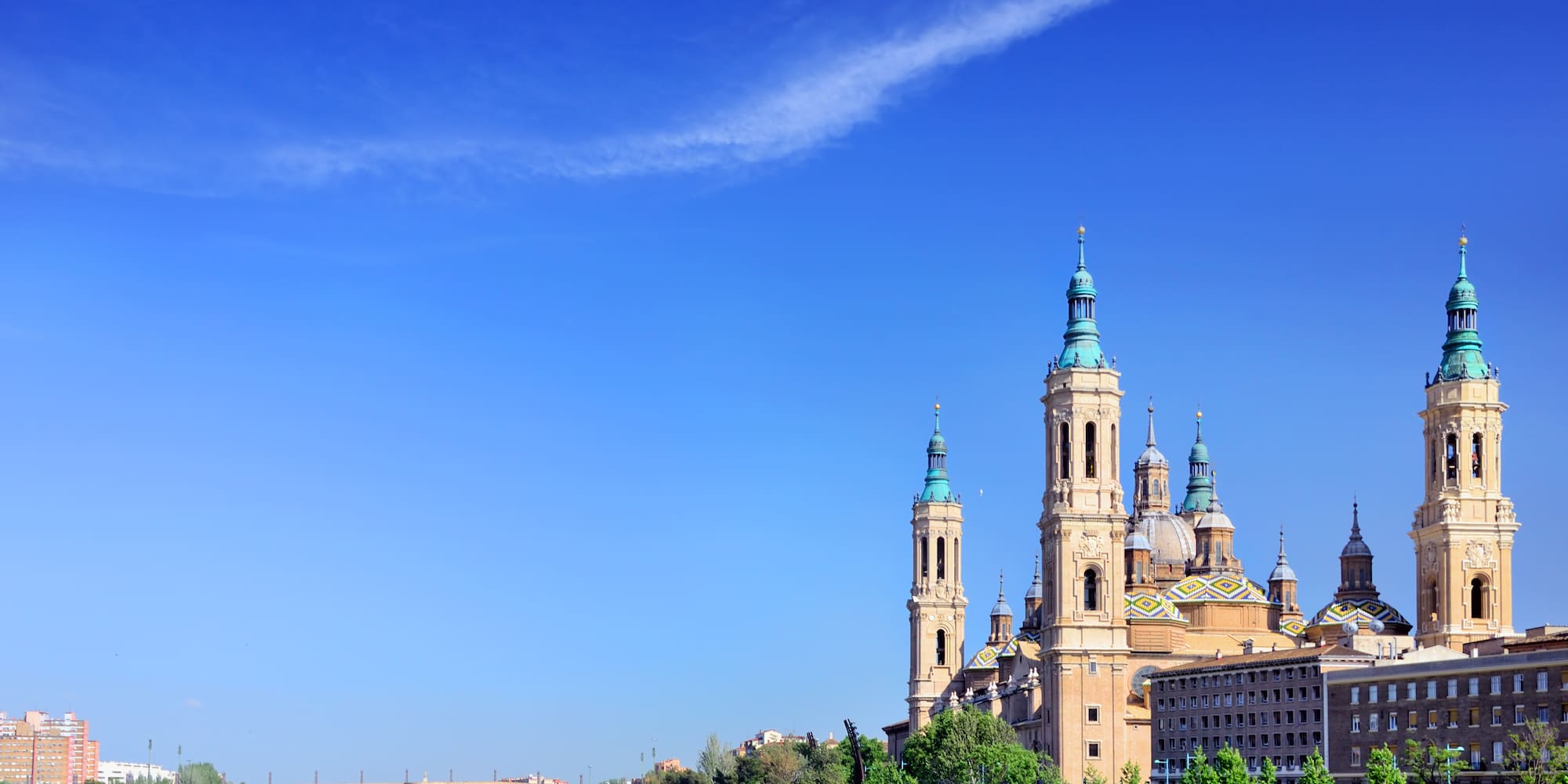 a river with a bridge and a city with towers